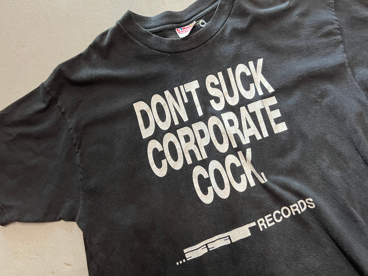 Vintage Don't Suck Corporate Cock SST Records Promotional Black T-Shirt - Close Up of Front View "Don't Suck Corporate Cock. ...SST Records" in white ink