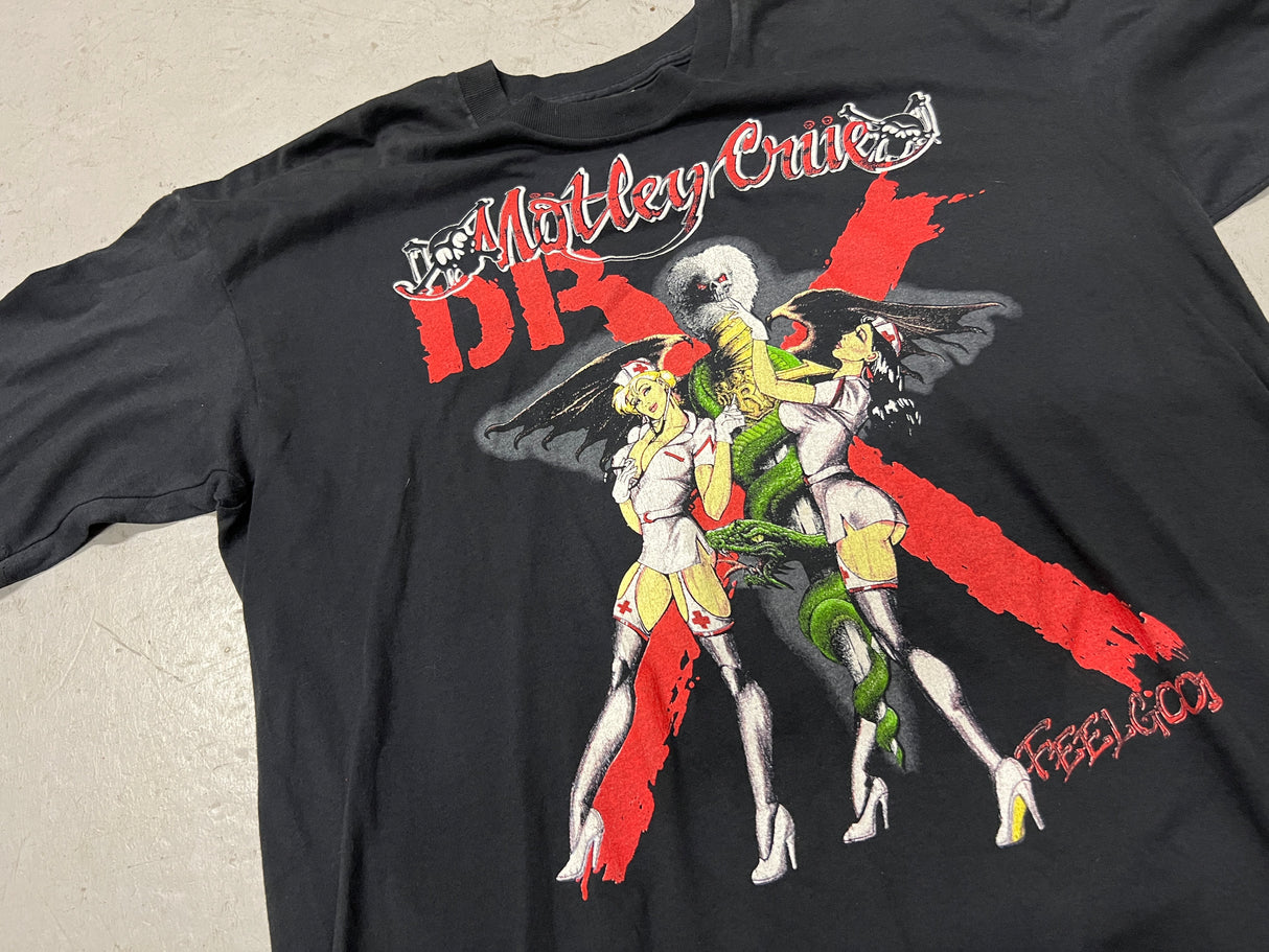 Vintage Motley Crue Dr. Feel Good Tour Shirt - Close up photo of front of shirt showing two nurses on a snake wrapped blade with "Motley Crue" text above image and Dr X behind image