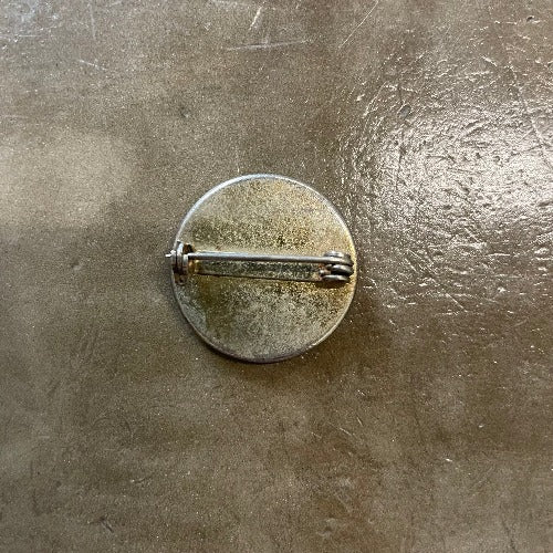 Madness pin back - silver with some light surface rust and aging