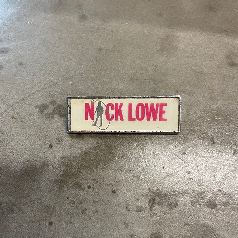 Nick Lowe Pin Front Red text on white backdrop with outline of body as the "I"