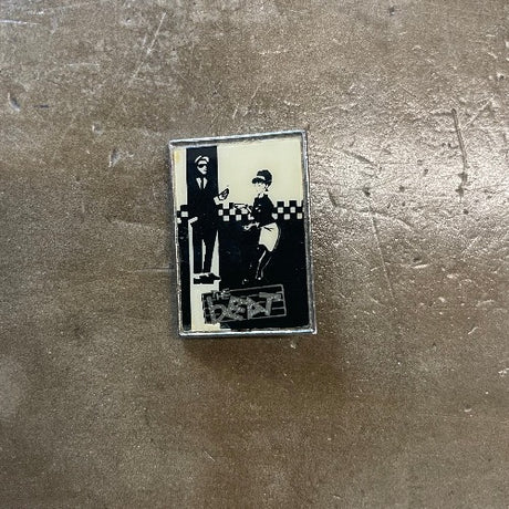 The Beat Enamel Pin Black and white colored with silver text