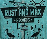Close up of Rust & Wax "Florida Tourist Trap" design on a seafoam colored t-shirt